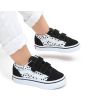 Bebé con Zapatillas Vans TD Old Skool V Dalmatian negras y blancas con velcro 