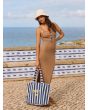 Mujer posando junto al mar con la bolsa de playa Roxy Fairy Beach Azul a rayas
