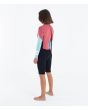 Mujer con neopreno corto Hurley Air 2mm MId Shorty Springsuit de manga  larga color Spiced Coral posterior izquierda