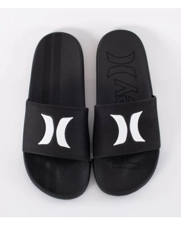 Chanclas Hurley Magu Slide negras y blancas para hombre con logotipo Hurley blanco sobre pala negra